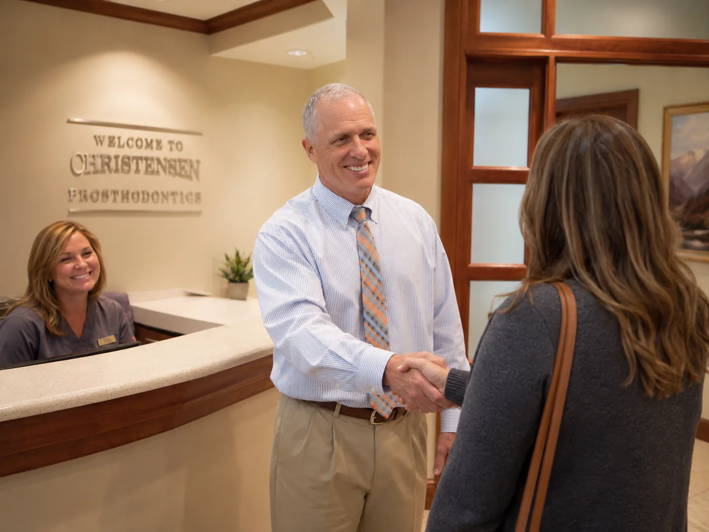Christensen Prosthodontics doctor greeting a patient with a handshake at the Orem Utah prosthodontics office